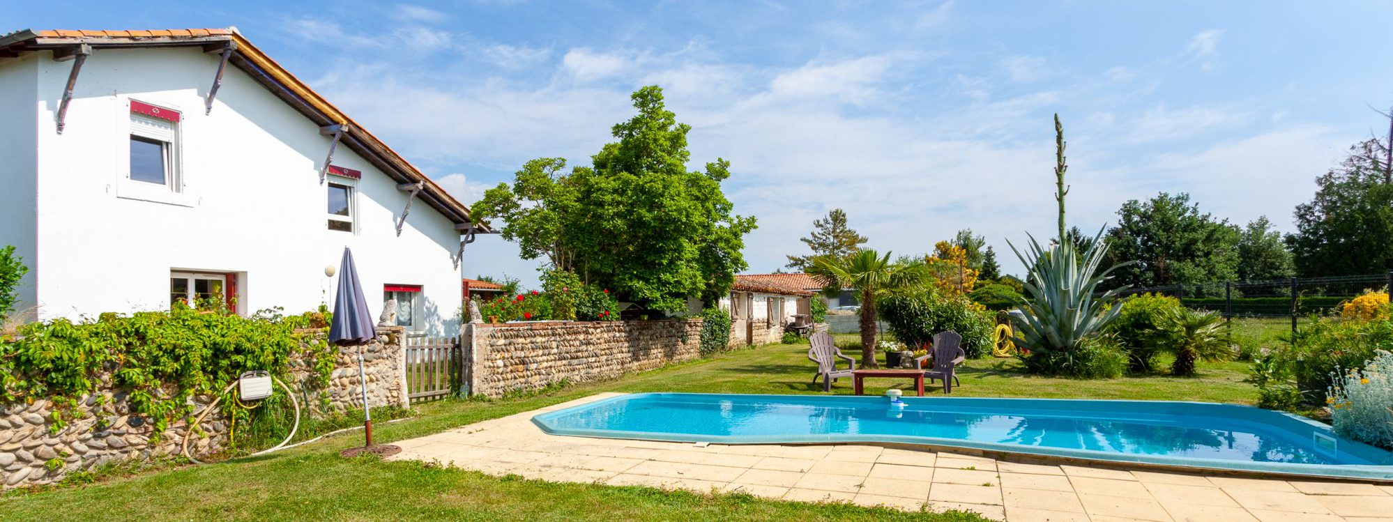 Vue extérieure du gîte L'Atelier de la Mandille avec piscine et jardin, à Saint-Élix-le-Château (31) en Haute-Garonne