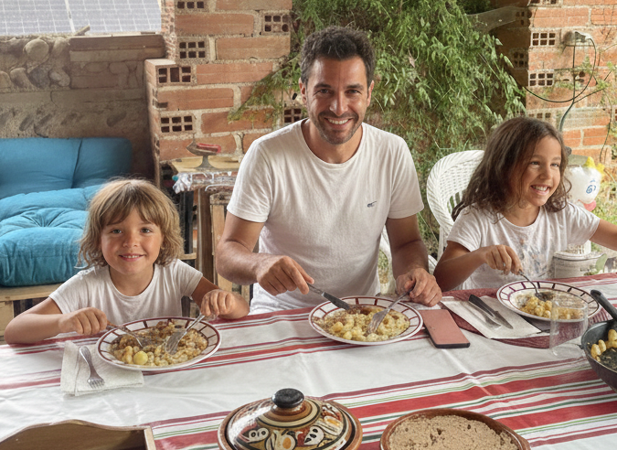Family enjoying a relaxed outdoor dining experience in the garden of Atelier de la Mandille, Saint-Élix-le-Château, Haute-Garonne